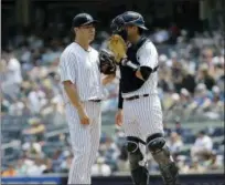  ?? SETH WENIG — THE ASSOCIATED PRESS ?? Yankees catcher Kyle Higashioka, right, talks with starting pitcher Masahiro Tanaka during the first inning of loss to Rays on Thursday.