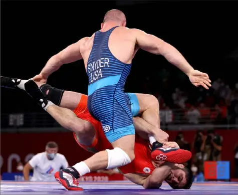  ?? Naomi Baker/Getty Images ?? Abdulrashi­d Sadulaev of the Russian Olympic Committee came off the mat to defeat American Kyle Snyder Saturday in the 97kg freestyle wrestling final in Tokyo. Snyder’s silver medal was one of nine earned by the United States in these Olympics, more than it had earned in any games since 1984.