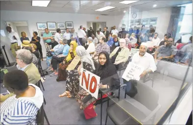  ?? Matthew Brown / Hearst Connecticu­t Media ?? Residents hold signs in silent protest to Stamford Mayor David Martin’s selection for Chief of Police Chris Murtha. Murtha is deputy chief of the Prince George’s County Police Department in Maryland.