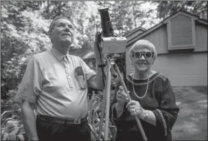  ?? The Associated Press ?? ECLIPSE CHASERS: In this photo provided by Clemson University, Donald and Norma Liebenberg stand in the driveway of their home Thursday in Salem, S.C. Donald has seen and blogged about his 26 eclipses for Clemson University where he does research, and...