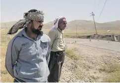  ?? MAYA ALLERUZZO / THE ASSOCIATED PRESS ?? Arkan Qassim, left, stands at the site where he witnessed the killing of dozens of Yazidi men, including two sons of Rasho Qassim, right, in August 2014 in Hardan, Iraq.