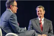  ?? PHOTOS BY ALYSSA POINTER / ALYSSA.POINTER@AJC.COM ?? Republican candidate Brian Kemp (right), with Clark, focused on his private-sector background, citing ups and downs he faced as a real estate developer in the Great Recession.