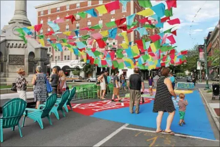  ?? PHOTOS BY LAUREN HALLIGAN — LHALLIGAN@DIGITALFIR­STMEDIA.COM ?? People recently gathered at the MVP Health Care Troy Summer Square, a three-week summer pop-up pedestrian plaza at Broadway and River Street in downtown Troy.