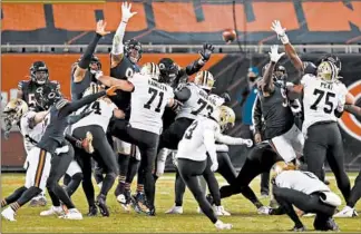  ?? BRIAN CASSELLA/CHICAGO TRIBUNE ?? The Saints’ Wil Lutz kicks the winning field goal against the Bears in overtime last week at Soldier Field.