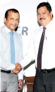  ??  ?? The outgoing Chairman congratula­ting the new Chairman