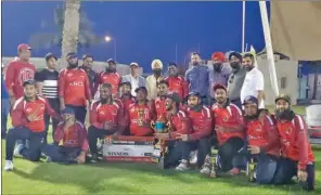  ?? ?? KRCC team members with the trophy along with guests and officials after they defeated United Spartans in the final by 94 runs at the Messaieed Industrial City ground on Friday.