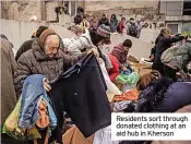  ?? ?? Residents sort through donated clothing at an aid hub in Kherson
