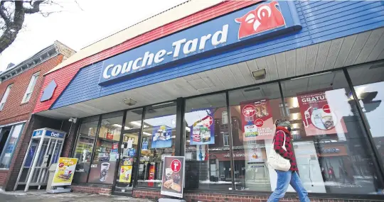  ?? BLOOMBERG ?? A pedestrian walks past a Couche-Tard convenienc­e store in Montreal on Wednesday.