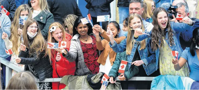  ?? KEITH GOSSE • THE TELEGRAM ?? Schoolchil­dren wave flags as Prince Charles and his wife, Camilla, Duchess of Cornwall, arrive at the Confederat­ion Building in St. John’s Tuesday, May 17, to begin their royal visit to Canada.