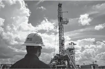  ??  ?? A Diamondbac­k Energy rig drills for oil and gas in September outside of Midland. Almost 300 rigs are drilling in the area now, more than double the number in May.