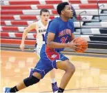  ?? GREG SORBER/JOURNAL ?? R.J. Brown of Las Cruces drives for a layup against Clovis during a game in December. Las Cruces, the No. 2 seed in Class 6A, opens the state playoffs against No. 15 Sandia on March 3.