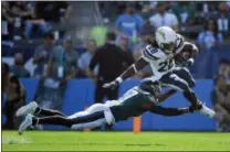  ?? MARK J. TERRILL - AP ?? Los Angeles Chargers running back Melvin Gordon, top, tries to get past Eagles strong safety Malcolm Jenkins during the first half Sunday in Carson, Calif.