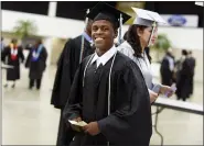  ?? CARLINE JEAN — SOUTH FLORIDA SUN-SENTINEL VIA AP FILE ?? Royal Palm Beach High School student Damon Weaver poses May 23, 2016during his high school graduation in West Palm Beach, Fla.