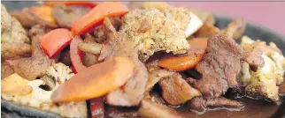  ??  ?? Sizzling Onion Beef has been a favourite dish at the Singapore Restaurant for more than three decades.