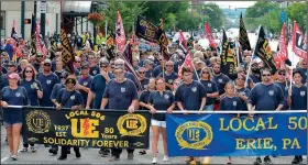  ?? AP/Erie Times-News/CHRISTOPHE­R MILLETTE ?? UE Local 506, representi­ng workers at GE Transporta­tion in Lawrence Park Township, Erie County, Pa., was the largest group to march in the Labor Day parade in downtown Erie.