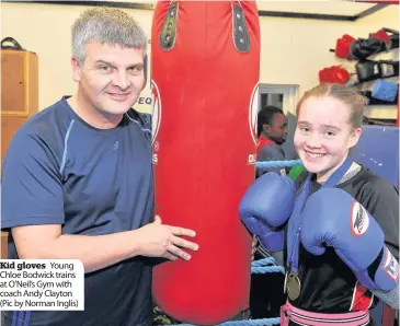  ??  ?? Kid gloves Young Chloe Bodwick trains at O’neil’s Gym with coach Andy Clayton (Pic by Norman Inglis)