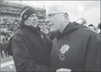  ?? CP PHOTO ?? Hamilton Tiger-cats head coach June Jones meets B.C. Lions head coach Wally Buono on the field following CFL division semifinal game in Hamilton, Ont., on Sunday.