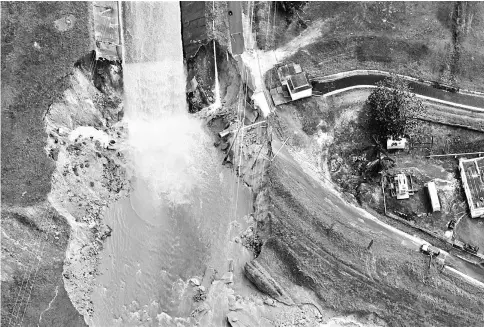  ??  ?? An aerial view shows the damage to the Guajataca dam in the aftermath of Hurricane Maria, in Quebradill­as, Puerto Rico. — Reuters photo