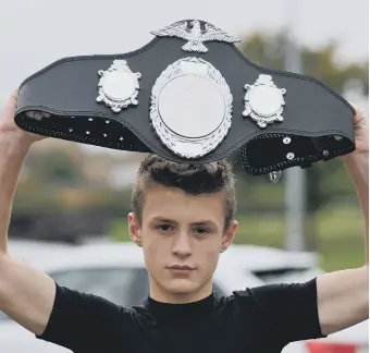  ??  ?? Zach Marshall with a belt he won at the Unified World Championsh­ips last year.