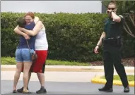  ?? The Associated Press ?? People console each other after a deadly shooting Monday, in Orlando, Fla.