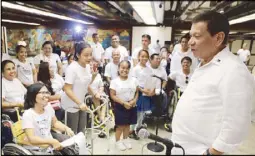  ??  ?? President Duterte talks to persons with disabiliti­es belonging to the Our Lady of Victory Training Center during a dinner he hosted at Malacañang on Wednesday. The President handed out P3.2million aid to the center.