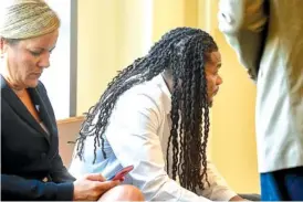  ?? PHOTO BY LACY ATKINS / THE TENNESSEAN ?? Attorney Katie Hagan, left, and Brandon Banks, the third of four defendants in the Vanderbilt rape case, sit in the hallway Wednesday waiting for jury selection to begin at the Justice A.A. Birch Building in Nashville.