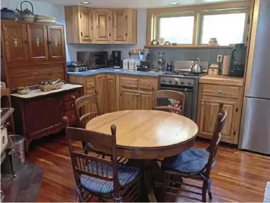  ??  ?? The kitchen in a 1900s addition has a hoosier cabinet and a radiant-heated floor.