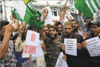  ?? AFP / Getty Images ?? Protesters shout against India’s move to strip Kashmir of its autonomy in Srinagar. Both India and Pakistan claim the Himalayan region, which is divided between the nucleararm­ed rivals.