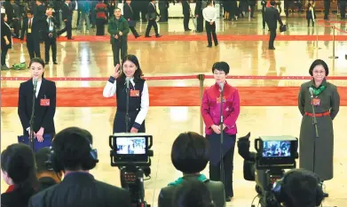  ?? YIN GANG/ XINHUA ?? Delegates Wu Minxia, Du Yutao, Meng Man and Lu Li-an (left to right) are interviewe­d by the media at the Great Hall of the People in Beijing on Wednesday before the opening of the 19th National Congress of the Communist Party of China.