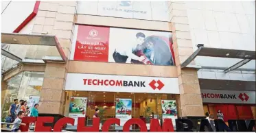  ?? — Reuters ?? More capital: A file picture showing Techcomban­k’s headquarte­rs in Hanoi. The bank aims to increase its registered capital by nearly three times this year to better compete with regional rivals.