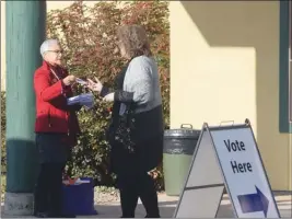  ?? JOE FRIES/Penticton Herald ?? Fair Vote BC organizer Lori Goldman speaks to a voter Thursday outside an advance poll at the Penticton Seniors’ Drop-In Centre.