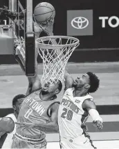  ??  ?? Pistons guard Josh Jackson (20) defends a shot by Sterling Brown. Jackson had a game-high 23 points.