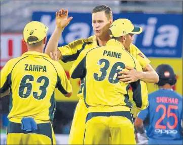  ?? PTI ?? Australia’s bowler Jason Behrendorf­f celebrates with teammates after taking the wicket of Rohit Sharma. He bowled 17 dot balls in his spell of 24 deliveries.