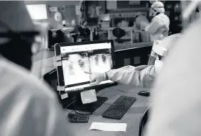  ??  ?? Prognosis
Medics review an X-ray taken of a patient at Hairmyres