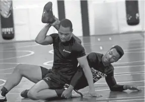  ??  ?? Jarvis Echols, left, wrestles his brother, Lennorise Echols, both 20.