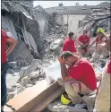  ??  ?? SEARCH: Rescuers pause during work in Amatrice in a bid to find survivors.