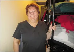  ?? NEWS PHOTO GILLIAN SLADE ?? Barbra Sullivan, assistant manager Champion Centre, stands in the locked storage room where people can leave their belongings on the shelves.