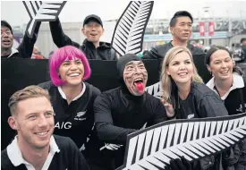  ??  ?? New Zealand fans pose for photos before a match.