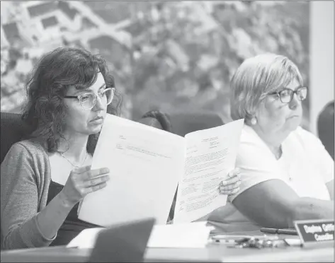  ?? MITCH MACDONALD/THE GUARDIAN ?? Coun. Daphne Griffin, left, looks over some files next to Coun. Debbie Johnston during Montague’s monthly council meeting Monday night. Griffin questioned whether council should make a long-term commitment to the Garden of the Gulf Museum with an...