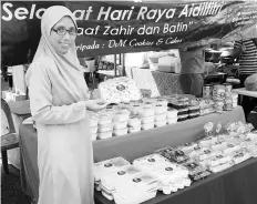  ??  ?? Kamisah with her cheese-cake based products at her stall at Sabindo Ramadan Bazaar.