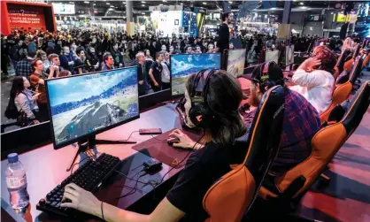  ?? ?? Competitor­s play at the Porte de Versailles exhibition centre during Paris Games week on 1 November 2019. Photograph: NurPhoto/Getty Images