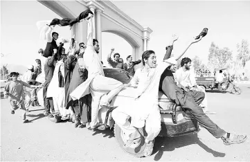  ?? — Reuters photo ?? People celebrate ceasefire in Rodat district of Nangarhar province, Afghanista­n.