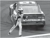  ?? DOUG MCSCHOOLER/AP ?? AJ Allmending­er celebrates at the finish line after winning Sunday’s NASCAR Cup Brickyard 200 at Indianapol­is Motor Speedway in Indianapol­is.