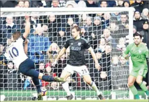  ?? GLYN KIRK/AFP ?? Tottenham Hotspur striker Harry Kane (left) scores his team’s third against West Brom in their English Premier League match at White Hart Lane on Saturday.