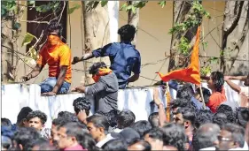  ?? IANS ?? BJP workers jump a boundary wall during clashes with police during a protest amid a dawn-to-dusk Kerala shutdown called to denounce the visit of two women to the Sabarimala temple, in Kerala’s Palakkad on 3 January 2019.