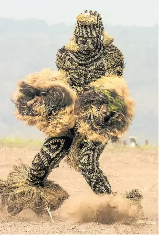  ??  ?? PENDE MUTHATHO MASK, DEMOCRATIC REPUBLIC OF CONGO Performers in ‘angry masks’ wearing netted raffia costumes dance frenetical­ly to amuse their audience.