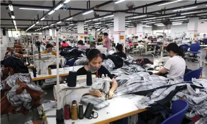  ?? Photograph: Nhac Nguyen/AFP/Getty Images ?? Factory workers endured gruelling conditions, living and sleeping in the same factories in which they worked long hours, to comply with strict government rules aiming to minimise the spread of Covid.