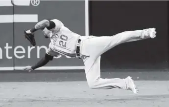  ?? Gregory Bull, The Associated Press ?? Rockies left fielder Ian Desmond is unable to reach a double hit by the Padres’ Austin Hedges during the seventh inning of Thursday night’s game in San Diego.