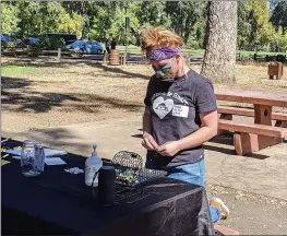  ?? PHOTOS BY JENNIE BLEVINS — CHICO ENTERPRISE-RECORD ?? Home & Heart program manager Sierra Schmidt calls out Bingo moves Sunday at Oak Grove Picnic Area in Bidwell Park.