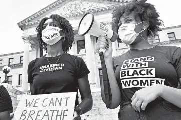  ?? SARAH WARNOCK/THE CLARION-LEDGER ?? Protesters, who did not wish to be identified, chant outside the Mississipp­i State Capitol building Friday in Jackson, Miss.